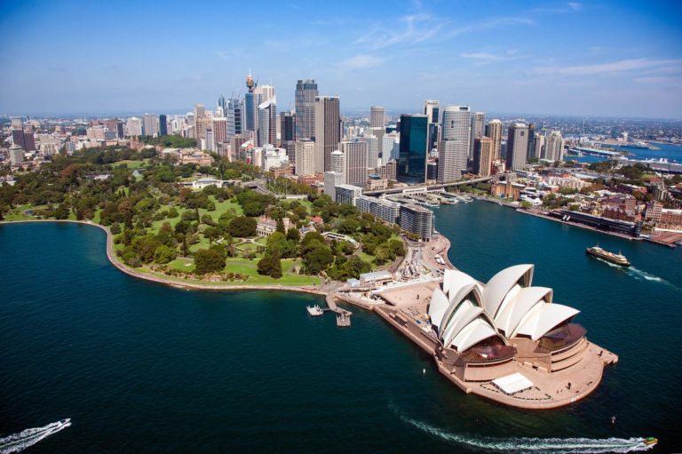 A body of water with a city in the background